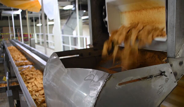 Outlaw Snax tortilla chips moving through the production process at the Ocala, Florida snack manufacturing facility.