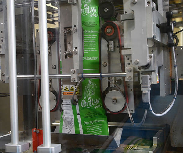 Outlaw Snax snack bags being filled and sealed on the packaging line at the Ocala, Florida manufacturing facility.